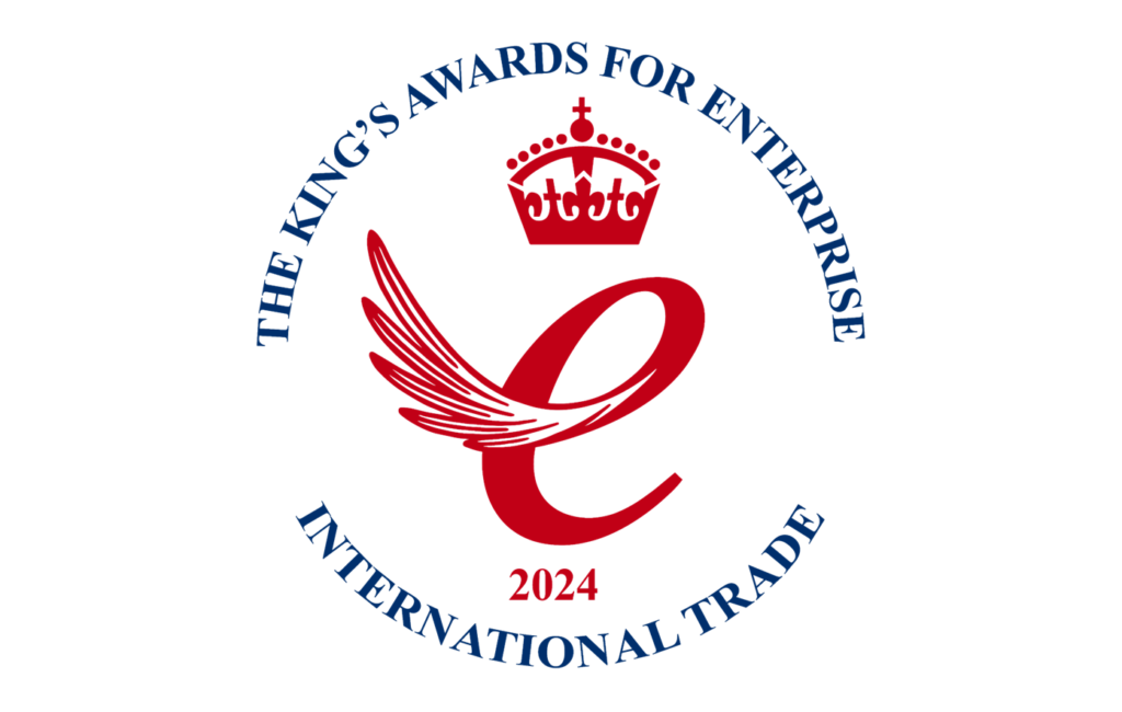 A dynamic single-winged lowercase letter e in a regal red, with a crown above the letter and the year 2024 centrally below, with text around it in a circle, The text in a circle is navy blue, in capital letters and boldly states "The King's Award for Enterprise" at the top, and "International Trade" below.